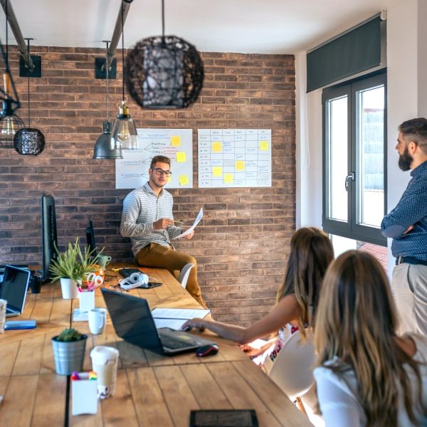 coach-giving-a-talk-to-workers-in-an-office-G4MNGC3-min